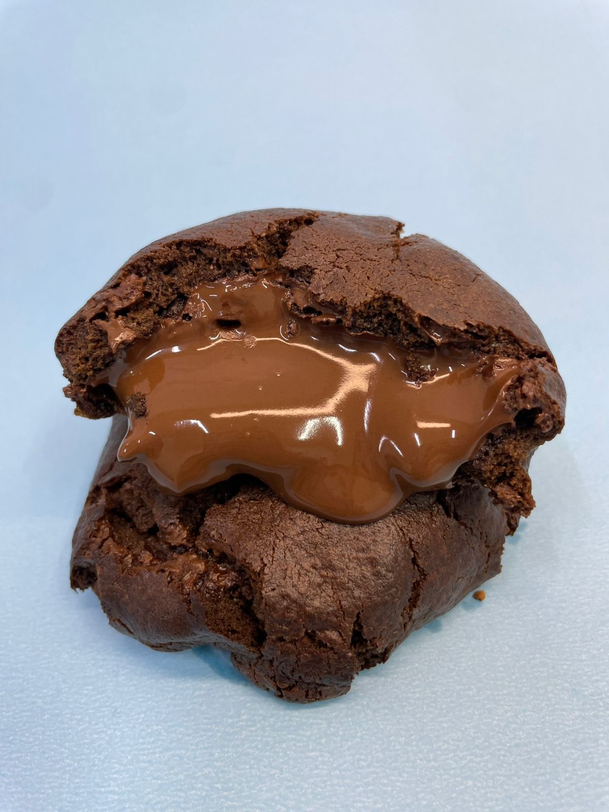 Cookie Chocolatudo com recheio de chocolate escorrendo